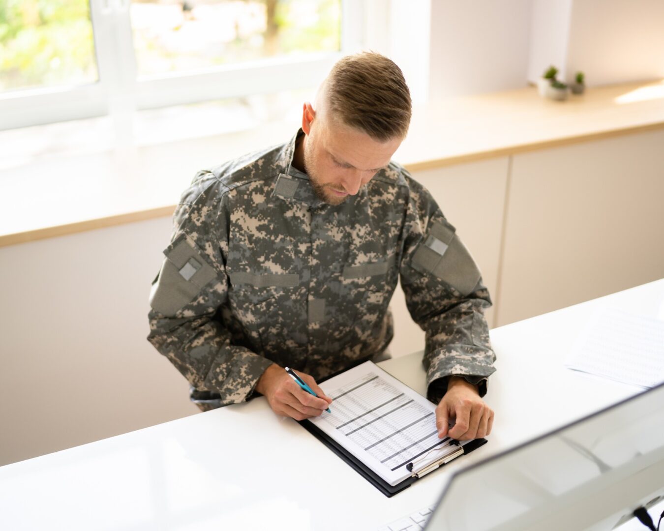 Army officer completing forms indoors